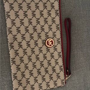 Michael Kors Beige and Burgundy Monogram Clutch
NWOT